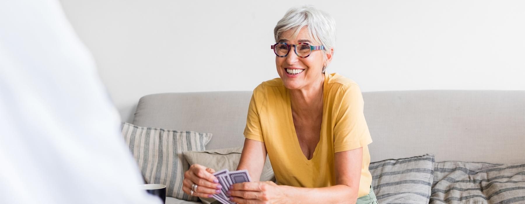 a person sitting on a couch playing cards