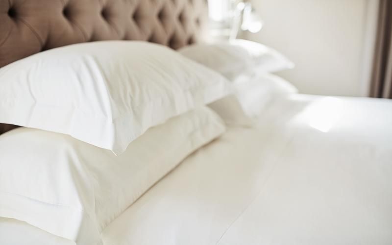 a bed with white pillows
